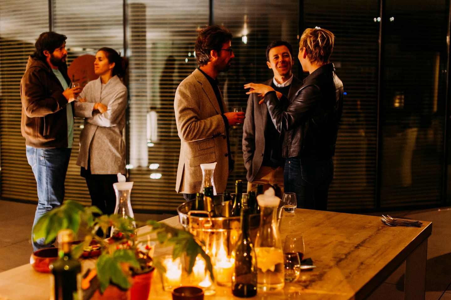 People mingling and talking at an evening networking event