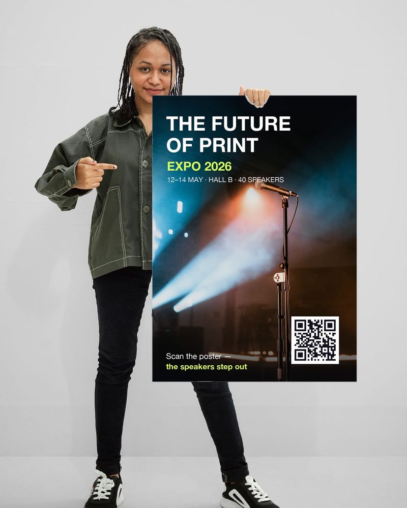 A woman holding an Expo 2026 poster with a QR code